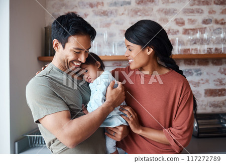 Down syndrome, happy family and baby in a kitchen, bonding and embracing in their home together. Child development, love and special needs care for disability by asian parents enjoy morning indoors 117272789