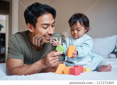 Baby, down syndrome and learning on a bed with child and father playing with educational blocks in a bedroom. Family, disability and kids bonding with asian parent, relax with creative activity Baby, down syndrome and learning on a bed with child and father playing with educational blocks in a bedroom. Family, disability and kids bonding with asian parent, relax with creative activity 117272805