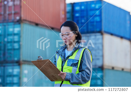 Logistics, Asian woman and check containers, export and import for supply chain at shipyard with clipboard. Female supervisor, planning or confirm storage cargo shipping, strategy and global business Logistics, Asian woman and check containers, export and import for supply chain at shipyard with clipboard. Female supervisor, planning or confirm storage cargo shipping, strategy and global business 117272807