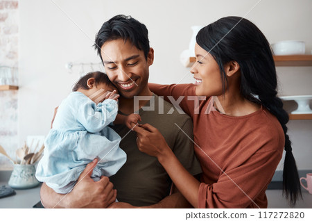 Love, baby and happy parents bonding and caring for their infant child in their comfy home. Happiness, smile and care with an interracial family, man and woman standing together in New york house 117272820