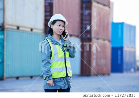 Logistics, phone call and woman talking about shipping container on a phone while working at port. Asian insdustrial employee speaking about distribution of cargo and stock on a mobile at a warehouse Logistics, phone call and woman talking about shipping container on a phone while working at port. Asian insdustrial employee speaking about distribution of cargo and stock on a mobile at a warehouse 117272835
