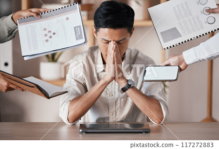 Stress, burnout and tired businessman overworked, overwhelmed and frustrated by his manager in an office. Headache, chaos and stressed out asian worker in trouble, struggle and mental health problems 117272883