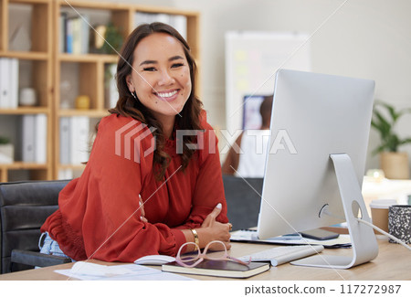 Asian business woman, working on computer at desk in office or company workplace with a smile. Portrait, happy employee and worker or manager, leader or ceo with corporate vision, mission strategy. 117272987