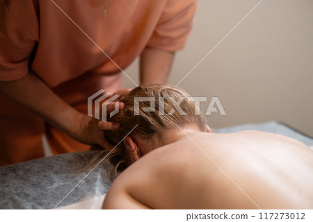 Head massage. Masseuse, client and scalp care, headache treatment and physiotherapy for healing Head massage. Masseuse, client and scalp care, headache treatment and physiotherapy for healing 117273012