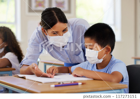 Covid, students and education teacher helping learning children in school classroom to answer math question. Woman with face mask teaching asian boy in lesson with diverse class of kids or classmates Covid, students and education teacher helping learning children in school classroom to answer math question. Woman with face mask teaching asian boy in lesson with diverse class of kids or classmates 117273151