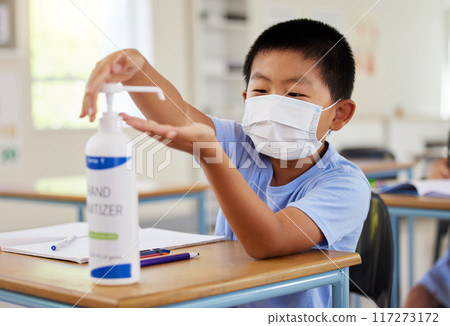 Covid, hand sanitizer and school student with mask cleaning, protecting and staying safe in education classroom. Small, little and cute asian boy in learning in study class preventing spread of virus Covid, hand sanitizer and school student with mask cleaning, protecting and staying safe in education classroom. Small, little and cute asian boy in learning in study class preventing spread of virus 117273172
