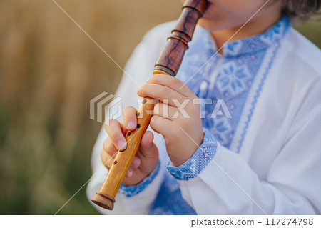 Hands Of Little Boy Kid Playing On Woodwind Wooden Flute - Ukrainian Sopilka Hands Of Little Boy Kid Playing On Woodwind Wooden Flute - Ukrainian Sopilka 117274798