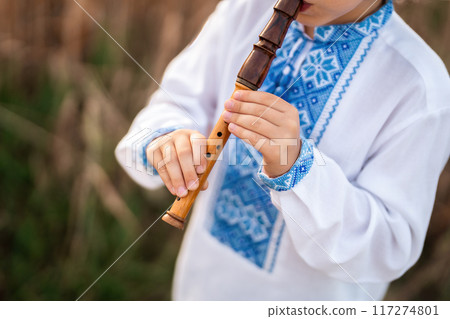 Hands Of Little Boy Kid Playing On Woodwind Wooden Flute - Ukrainian Sopilka 117274801