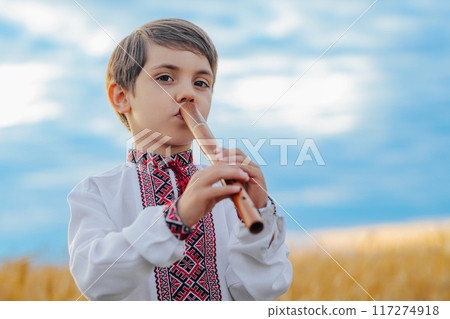 Little Boy Playing Folk On Woodwind Wooden Flute - Ukrainian Sopilka Or Tylynka 117274918