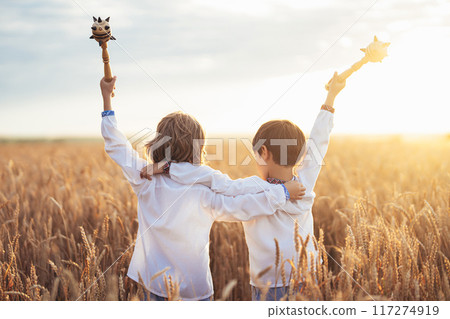 Portrait of happy little ukrainian children boys with maces - bludgeons wheat field. Bulava, Ukraine, peace. Kids in traditional embroidery vyshyvanka shirts. Brothers, freedom, patriots. Portrait of happy little ukrainian children boys with maces - bludgeons wheat field. Bulava, Ukraine, peace. Kids in traditional embroidery vyshyvanka shirts. Brothers, freedom, patriots. 117274919