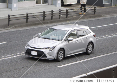 Compact car driving on the road 117275294
