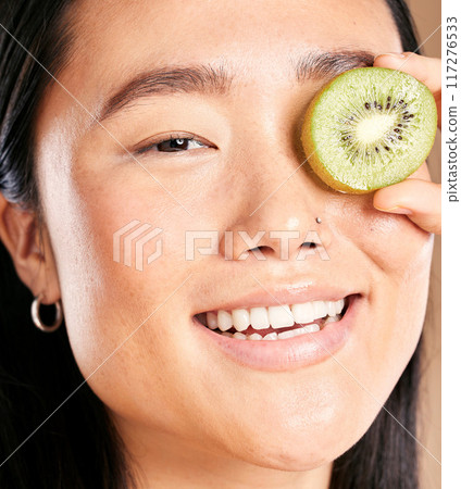 Asian woman, smile and kiwi skincare portrait for facial skincare wellness, luxury organic product and happy dermatology. Model, face and fruits vitamins for natural cosmetics happiness or skin glow Asian woman, smile and kiwi skincare portrait for facial skincare wellness, luxury organic product and happy dermatology. Model, face and fruits vitamins for natural cosmetics happiness or skin glow 117276533