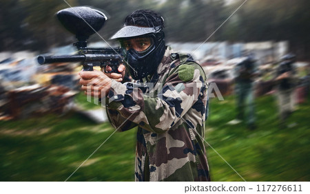 Man, paintball or gun aim in motion blur games arena or challenge in teamwork competition, sports or military training. Player, rifle or shooting equipment for soldiers, fast army or battlefield war 117276611