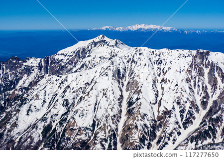 Climbing Mount Yari in the Northern Alps in early summer with snow remaining on the mountain. View from the summit of Mount Yari, Mount Kasagatake and Mount Hakusan. Climbing Mount Yari in the Northern Alps in early summer with snow remaining on the mountain. View from the summit of Mount Yari, Mount Kasagatake and Mount Hakusan. 117277650