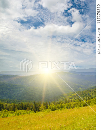 Picturesque mountain landscape with mountain ranges, coniferous forests and sunrise. 117279250