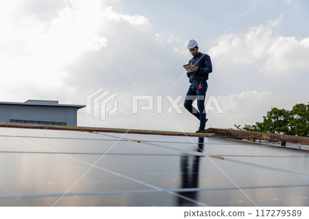 Engineer service check installation solar cell on the roof of factory. Engineer service check installation solar cell on the roof of factory. 117279589