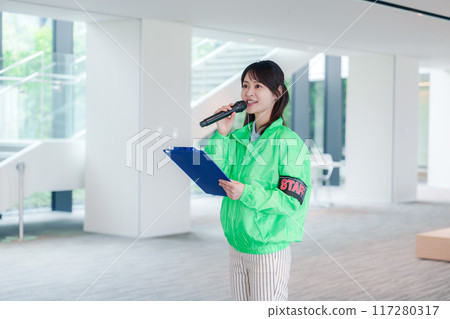 Event staff providing guidance with a smile Event staff providing guidance with a smile 117280317