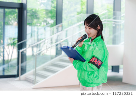 Event staff providing guidance with a smile 117280321