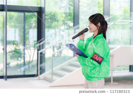 Event staff providing guidance with a smile 117280323