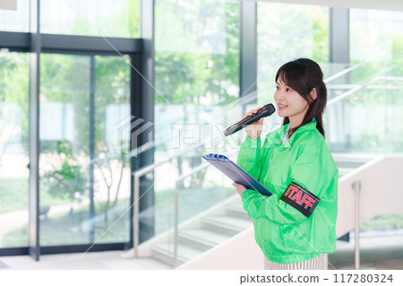 Event staff providing guidance with a smile 117280324