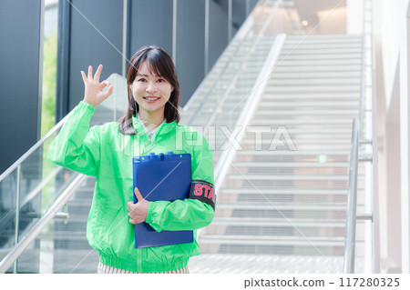 Event staff providing guidance with a smile 117280325