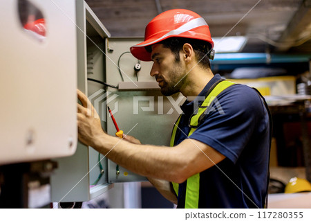 Electrical engineer man checking Power Distribution Cabinet in the control room Electrical engineer man checking Power Distribution Cabinet in the control room 117280355