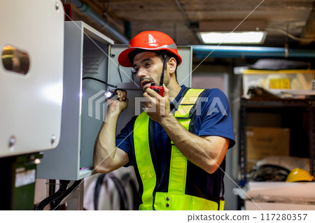 Electrical engineer man checking Power Distribution Cabinet in the control room Electrical engineer man checking Power Distribution Cabinet in the control room 117280357