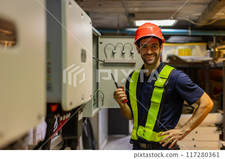 Electrical engineer man checking Power Distribution Cabinet in the control room Electrical engineer man checking Power Distribution Cabinet in the control room 117280361