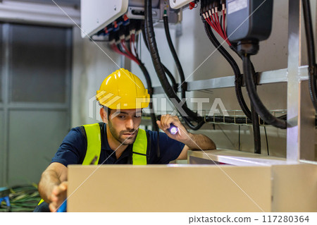 Electrical engineer man checking Power Distribution Cabinet in the control room 117280364