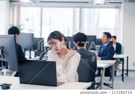 Businesswoman tired from long hours of desk work 117280719