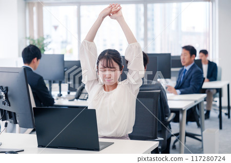 Businesswoman tired from long hours of desk work 117280724