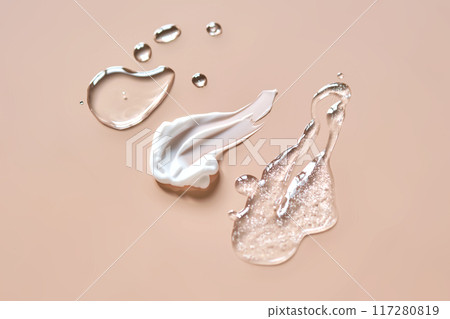 Three cosmetic products on a beige background. Three cosmetic products on a beige background. 117280819