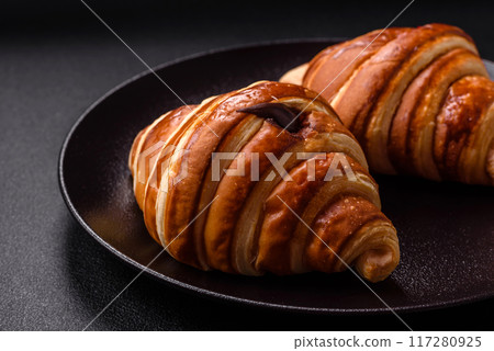 Delicious crispy sweet croissant cornet with chocolate Delicious crispy sweet croissant cornet with chocolate 117280925