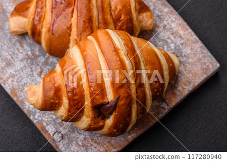 Delicious crispy sweet croissant cornet with chocolate Delicious crispy sweet croissant cornet with chocolate 117280940
