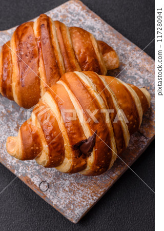 Delicious crispy sweet croissant cornet with chocolate 117280941