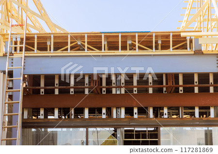 Roofing frame truss installation under construction on house Roofing frame truss installation under construction on house 117281869