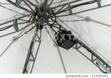 A distinctive lighting fixture hangs from a structural framework A distinctive lighting fixture hangs from a structural framework 117281941