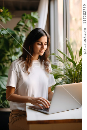 Young woman using laptop at home, remote work concept 117282789