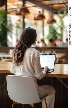 Mockup white screen laptop woman using computer remote work in coworking space 117282815