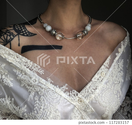 Portrait of a young woman in unusual massive jewelry 117283157