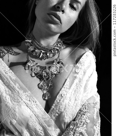 Portrait of a young woman in unusual massive jewelry Portrait of a young woman in unusual massive jewelry 117283226