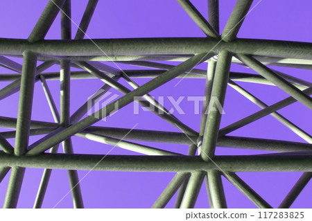 Abstract metal figure on a colorful pink background, artistically welded metal pipes, fragment of scaffolding in NYC Abstract metal figure on a colorful pink background, artistically welded metal pipes, fragment of scaffolding in NYC 117283825