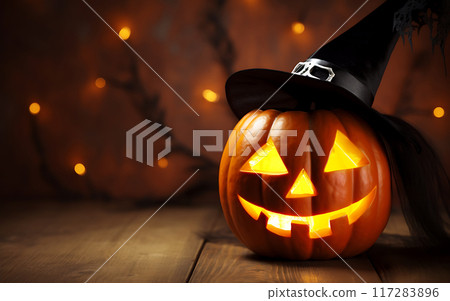 Halloween pumpkin head in a hat on a wooden table with glowing lights on the background 117283896