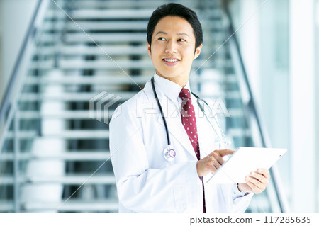 A man wearing a white coat A man wearing a white coat 117285635