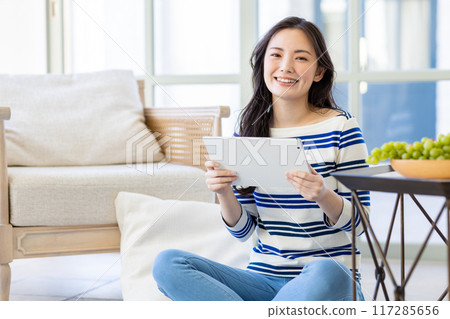 Young woman living alone Young woman living alone 117285656
