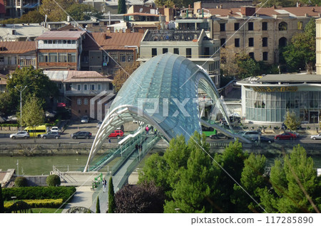 Georgia, Tbilisi, trendy symbol landmark, beautifully deformed green Peace Bridge 117285890