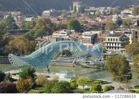 Georgia, Tbilisi, trendy symbol landmark, beautifully deformed green Peace Bridge 117286010