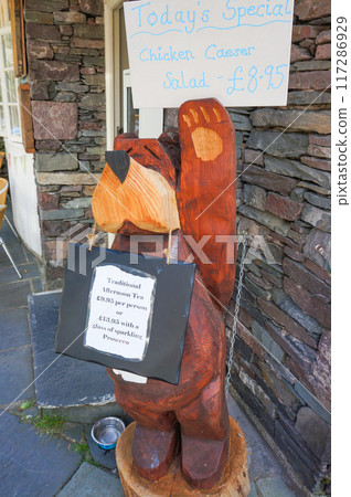 A bear ornament placed in front of a store A bear ornament placed in front of a store 117286929