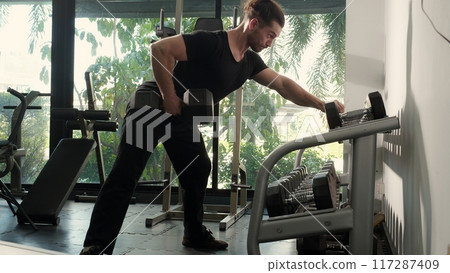 Young caucasian man training exercise or workout with lifting dumbbell for bodybuilder with strong. Young caucasian man training exercise or workout with lifting dumbbell for bodybuilder with strong. 117287409