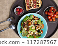 A vibrant, tempting breakfast with colorful salad, shrimp, ripe tomato, sandwich, bananas, fresh strawberries. Wholesome meal offers a delicious nutrients, providing energy, essential vitamin, healthy 117287567